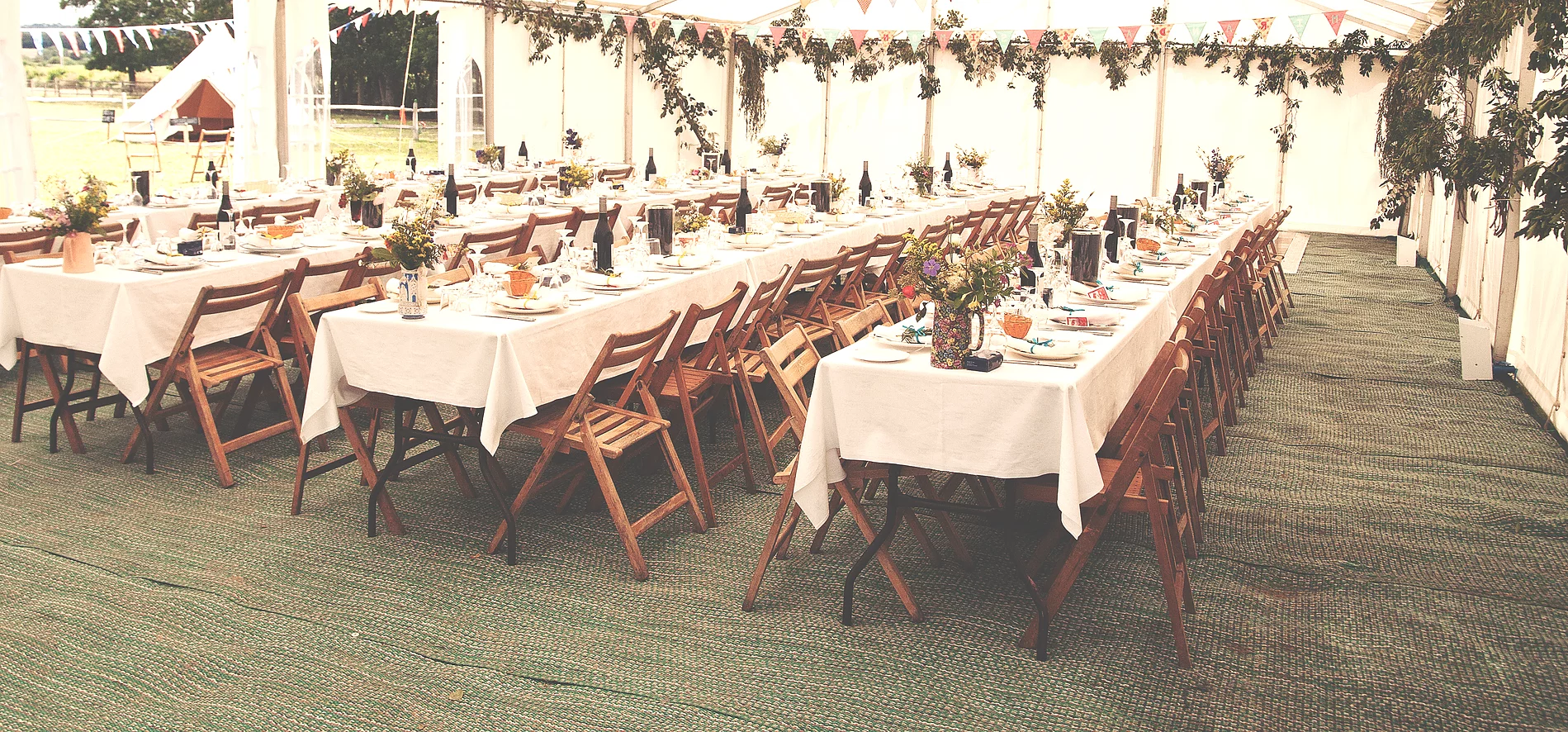 A long reception table dressed in white